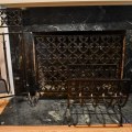 D02. Acorn and oak leaf iron fire screen, log rack and fireplace tools. 